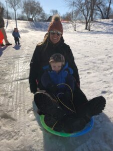 lady with boy sledding