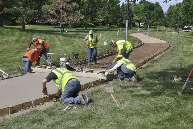 construction crew laying sidewalk