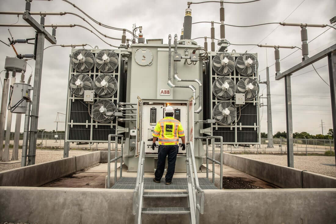 one person standing in front of a substation