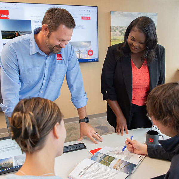 group of Ulteig employees working on a document
