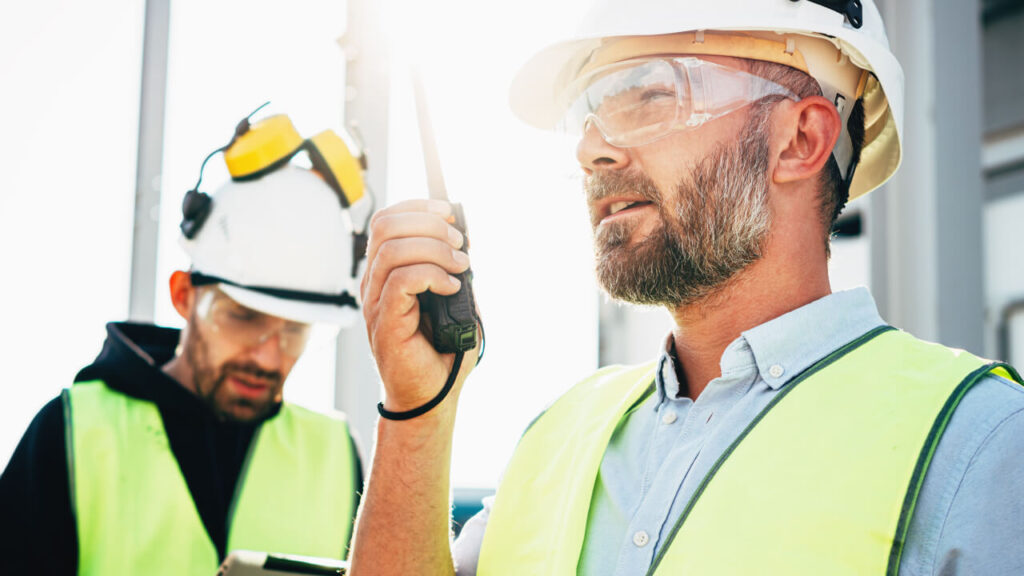 Utility worker talking on mobile radio