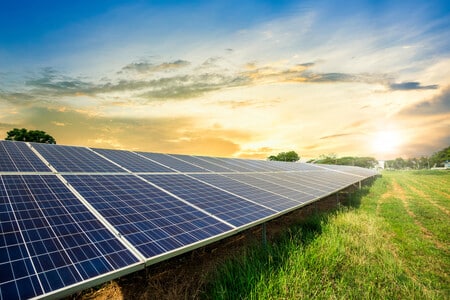 solar panel with sun shining behind