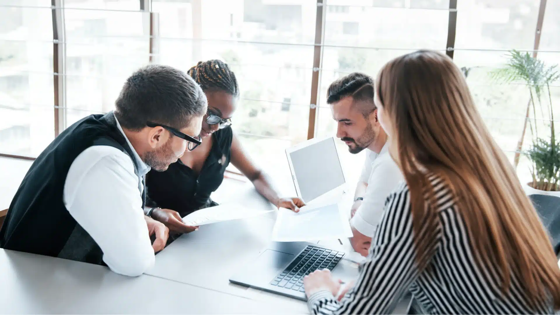people at a desk looking at a document